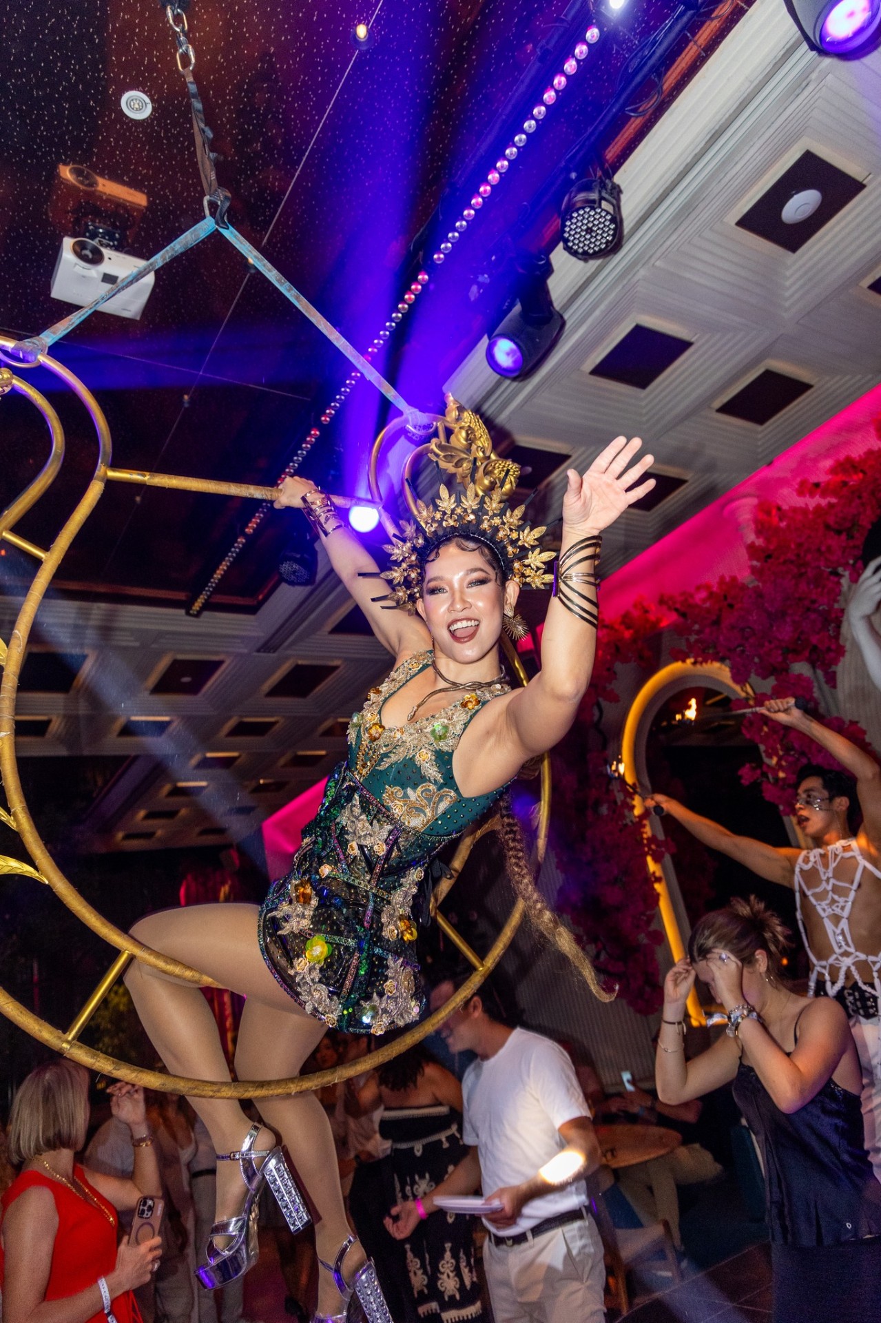 Aerialist suspended above the room