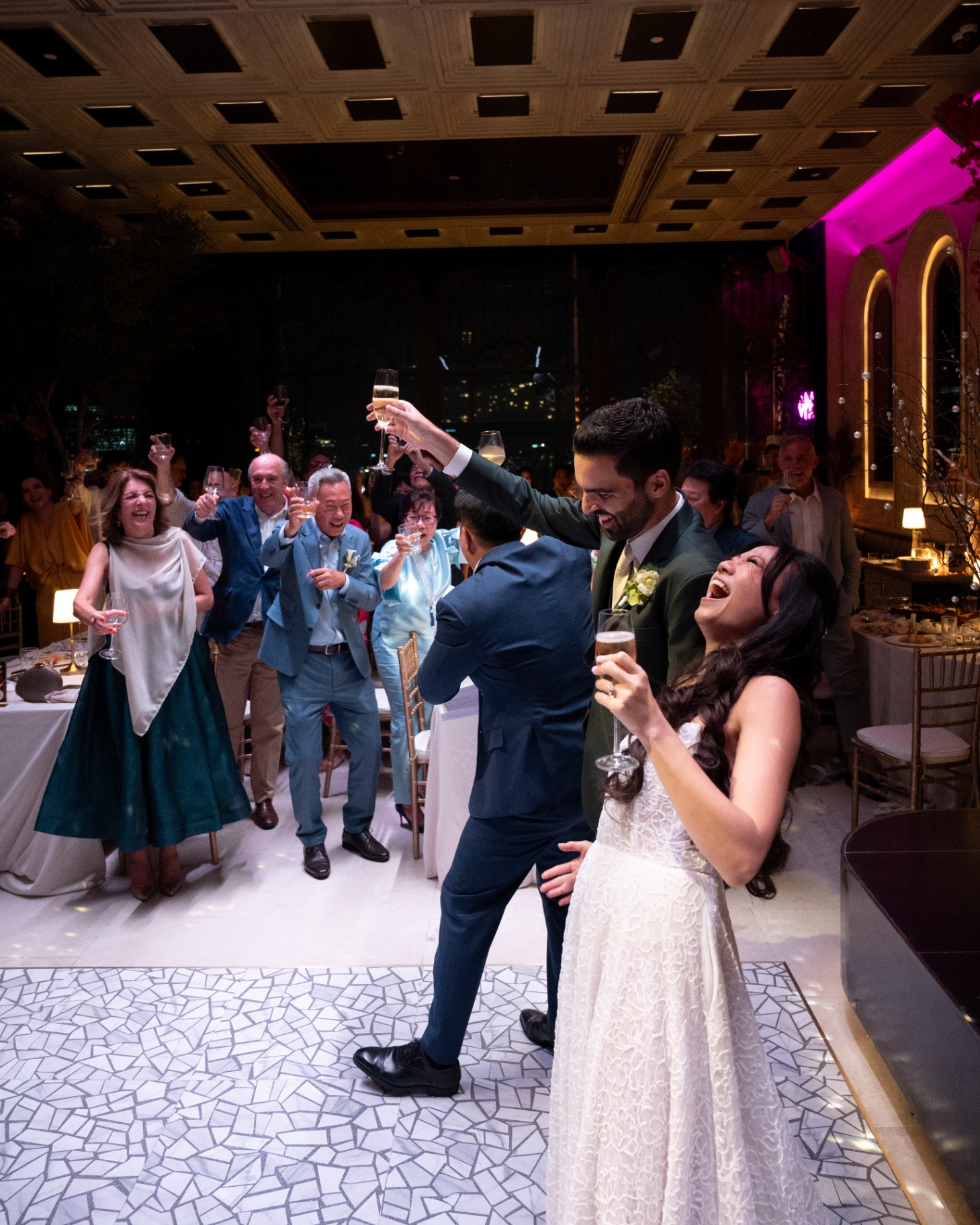 Bride and groom celebrating on the dancefloor with skyline behind