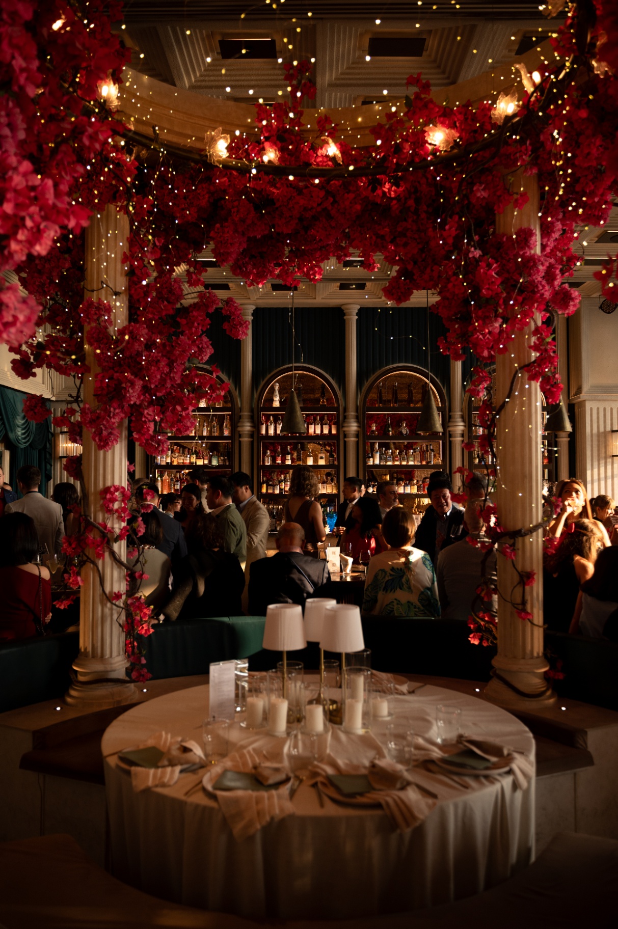 Bougainvillea-draped bar with couple beneath disco ball at an Aesops wedding